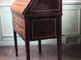 a small wooden desk with a drawer on top of it