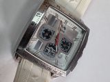 a close up of a watch on a white surface