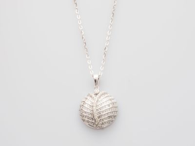 a white gold and diamond ball pendant on a silver chain