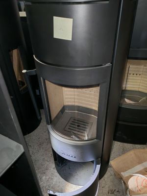 a black stove with a glass door and a box of donuts