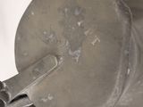 a close up of a metal object on a white surface