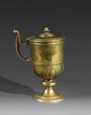 a gold cup that is sitting on a table