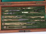 many different types of surgical instruments in a wooden case