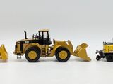 four toy construction vehicles that are lined up on a white surface