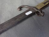 a close up of a sword with a tag on it