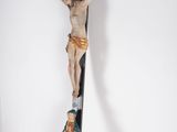 statue of jesus on the cross with a crucifix in the background