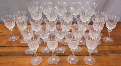 a lot of wine glasses sitting on a wooden table