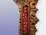 a mirror with a gold frame and a blue background