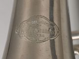 a silver trumpet that is sitting on a table