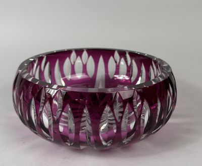 a purple glass bowl that is sitting on a table