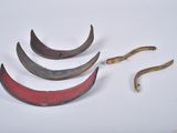 four pieces of metal that have been placed on a white surface