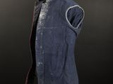 a blue vest on a mannequin stand with a black background