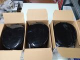 three boxes of black toilet seats sitting on top of a table