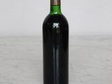 a bottle of wine sitting on a marble table