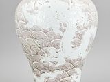 a white vase with a design on it on a gray background
