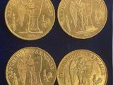 four gold coins with a picture of a man and a woman on them
