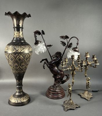 three vases and a candelab with flowers on them