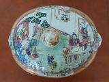 a bowl with a lid that has a picture of people on it