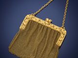 an antique gold mesh purse with a chain handle