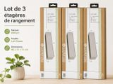 trois rouleaux de papier toilette posés sur une table, à côté d'une plante en pot