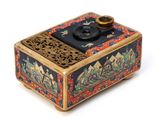 a small box with a lid that has a design on it