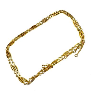 a close up of a gold chain bracelet on a white background