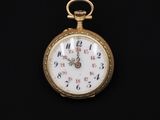 an antique pocket watch on a black background with a black background