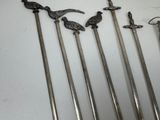 several different types of swords are displayed on a white surface