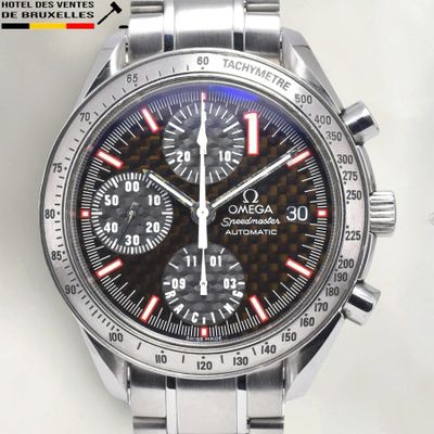 a close up of a watch on a white surface