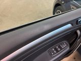 a close up of a car door handle with a car in the background