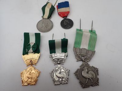 three medals and a medal are sitting on a white surface