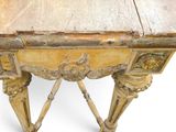 a small wooden table with carvings on the top