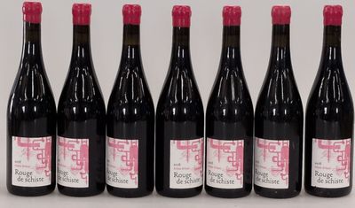 six bottles of wine are lined up on a table
