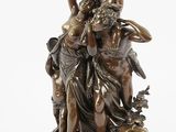 an image of a bronze statue of a woman and two men