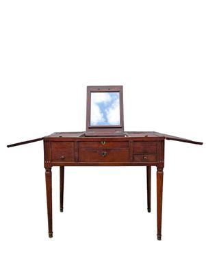 a laptop computer sitting on top of a wooden desk