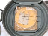 a bag of cheese in a blender with a piece of cheese in it