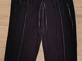 the pants are black and have a zipper at the waist