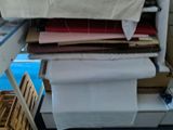 a stack of folded sheets on a shelf in a room