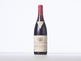 a bottle of red wine sitting on top of a table