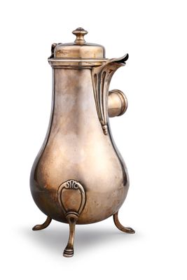 an antique silver coffee pot on a stand on a white background