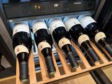 many bottles of wine sitting in a wine cooler