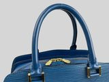 a close up of a blue handbag on a white background