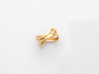 a gold ring on a white surface