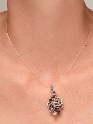 un gros plan d'une femme portant un collier orné d'un serpent