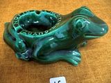 une grenouille verte assise sur une table sur laquelle se trouve une étiquette de prix