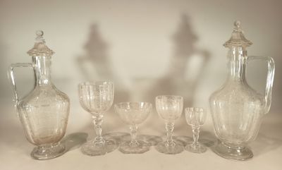 a group of wine glasses and a decanter on a table
