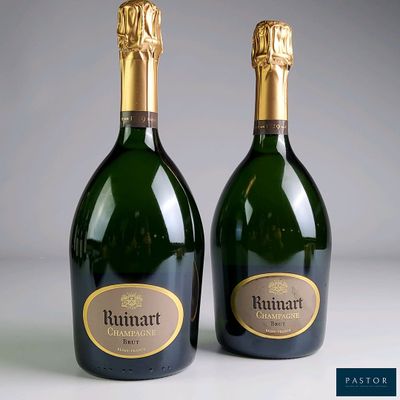 two bottles of champagne sitting next to each other on a table