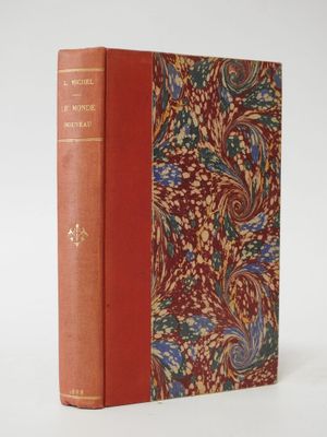 a book with a red cover sitting on top of a white table