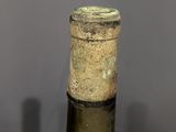 a bottle of wine sitting on top of a wooden table