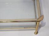 gold metal and glass coffee table with a glass top
